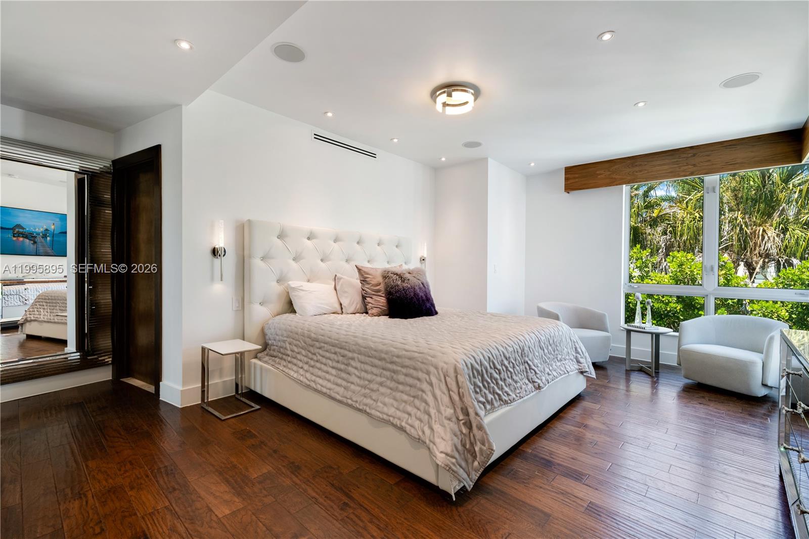 548 Fernwood Road, Unit 548 Key Biscayne, FL 33149 - Photo 15 of 50 a bedroom with a bed and wooden floor