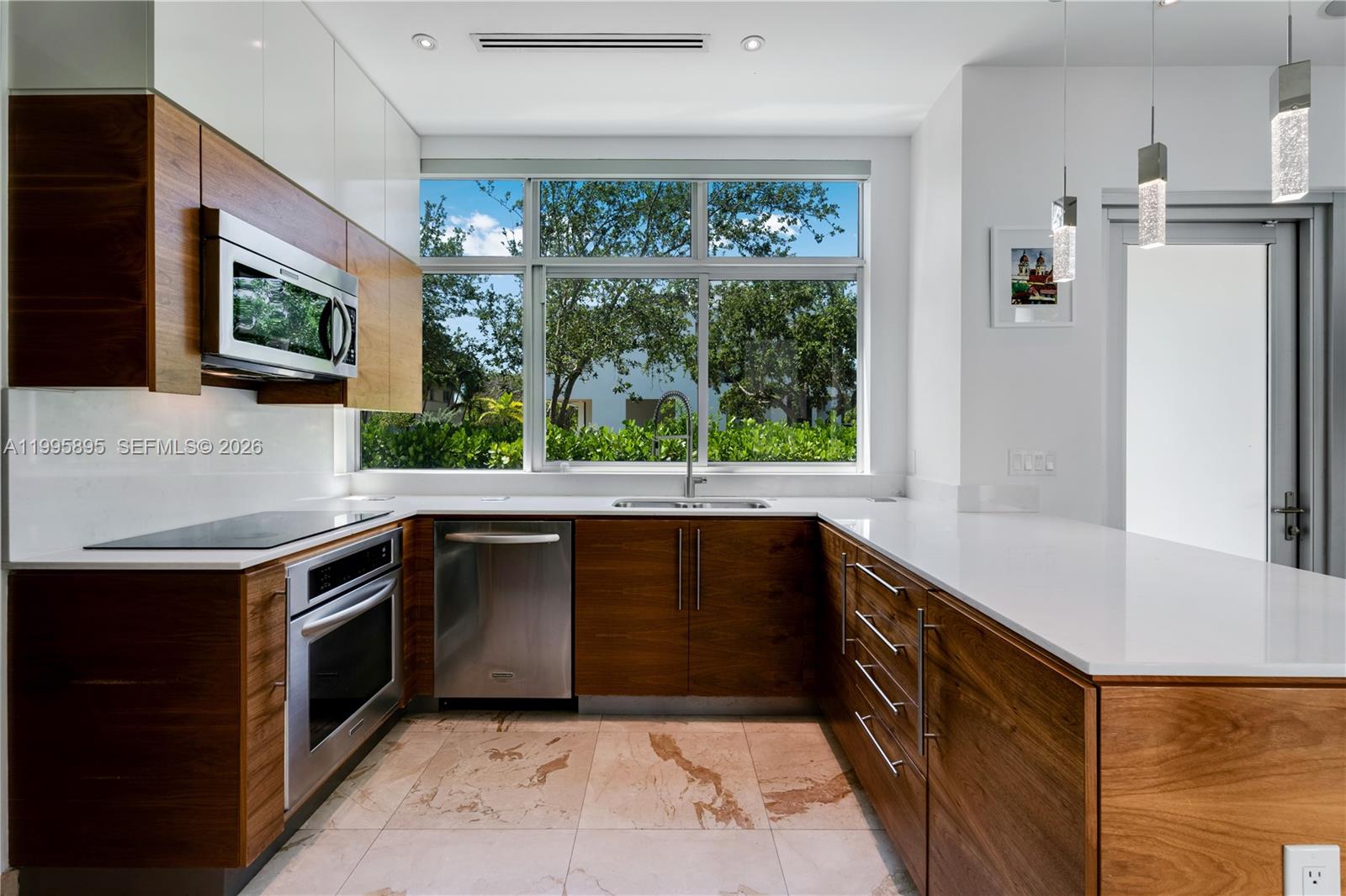 548 Fernwood Road, Unit 548 Key Biscayne, FL 33149 - Photo 2 of 50 a kitchen with a stove a sink and a refrigerator