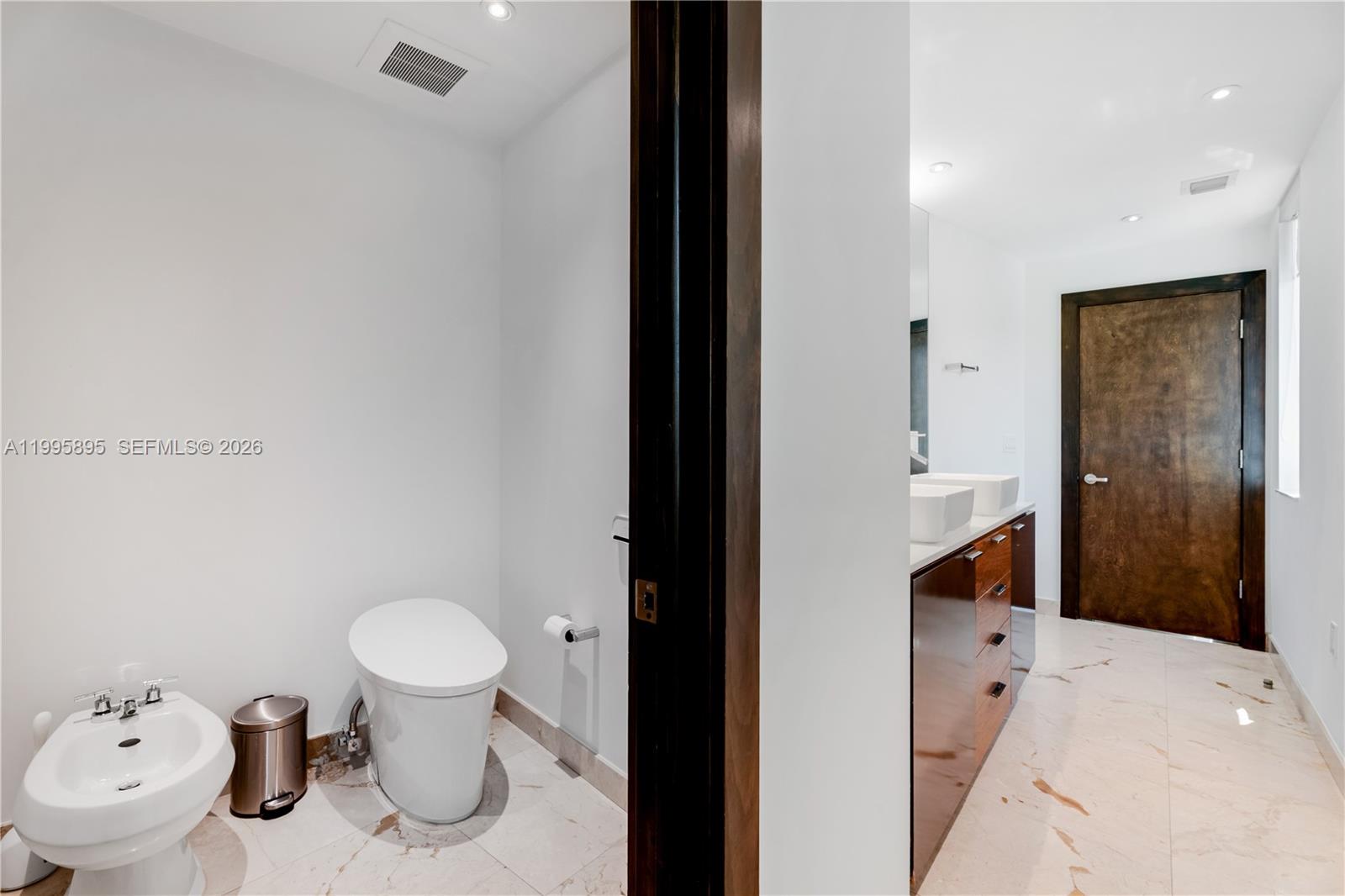 548 Fernwood Road, Unit 548 Key Biscayne, FL 33149 - Photo 23 of 50 a bathroom with a sink toilet and shower