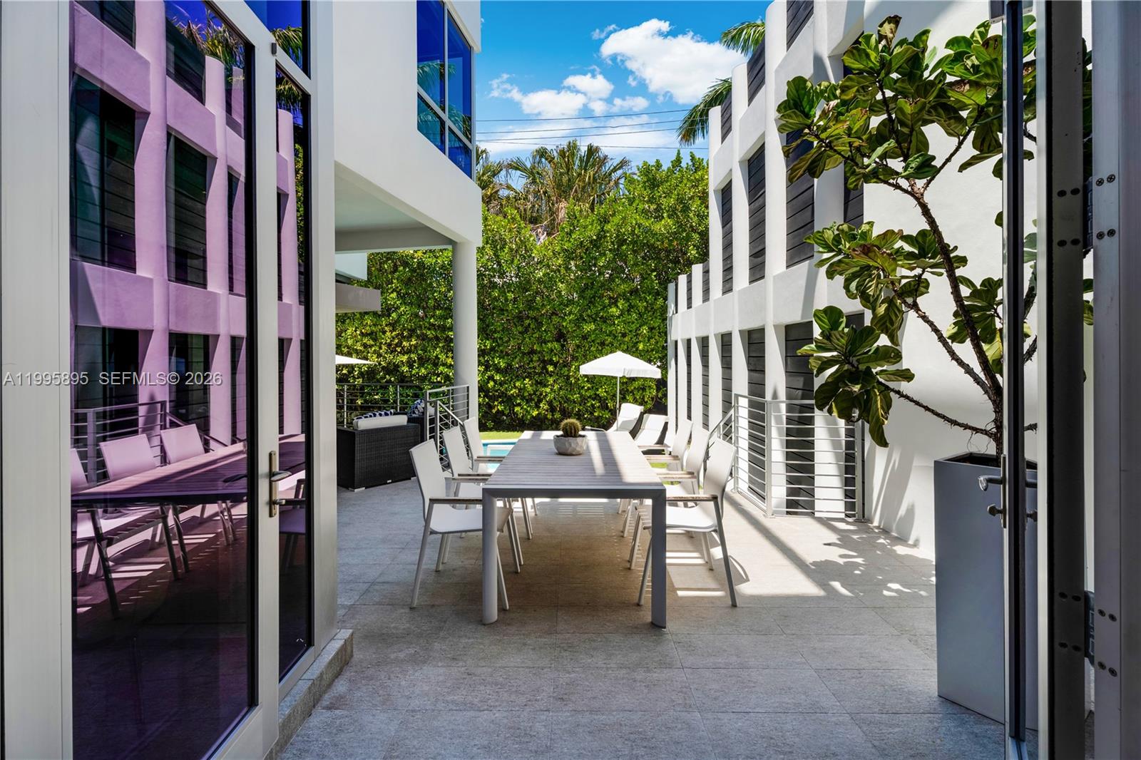 548 Fernwood Road, Unit 548 Key Biscayne, FL 33149 - Photo 30 of 50 a view of a patio with a table and chairs and potted plants