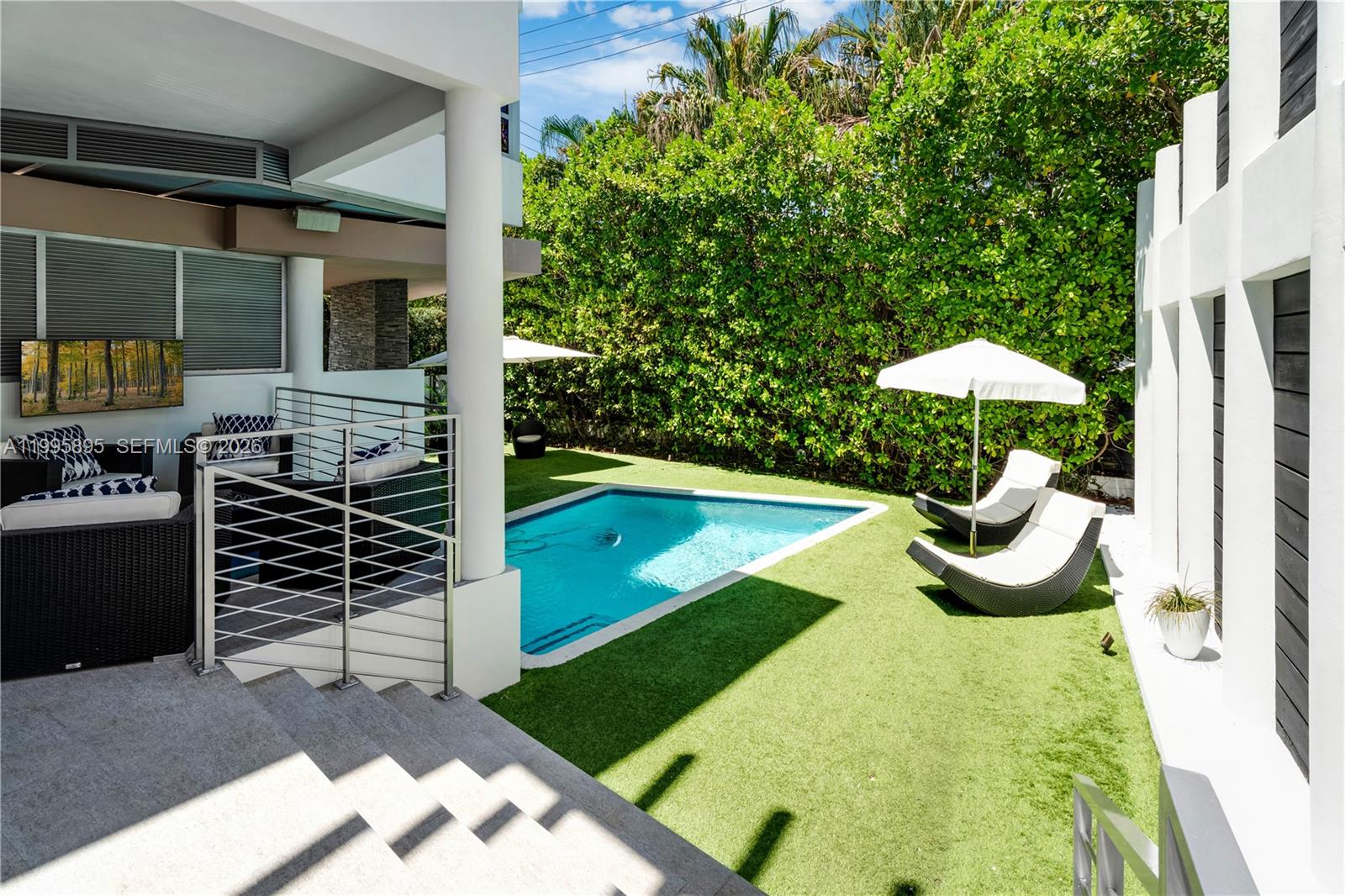 548 Fernwood Road, Unit 548 Key Biscayne, FL 33149 - Photo 34 of 50 a view of a swimming pool with an outdoor seating and a yard