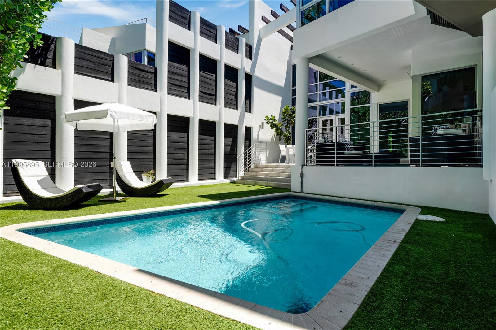 548 Fernwood Road, Unit 548 Key Biscayne, FL 33149 - Photo 37 of 50 a view of outdoor space with swimming pool and porch