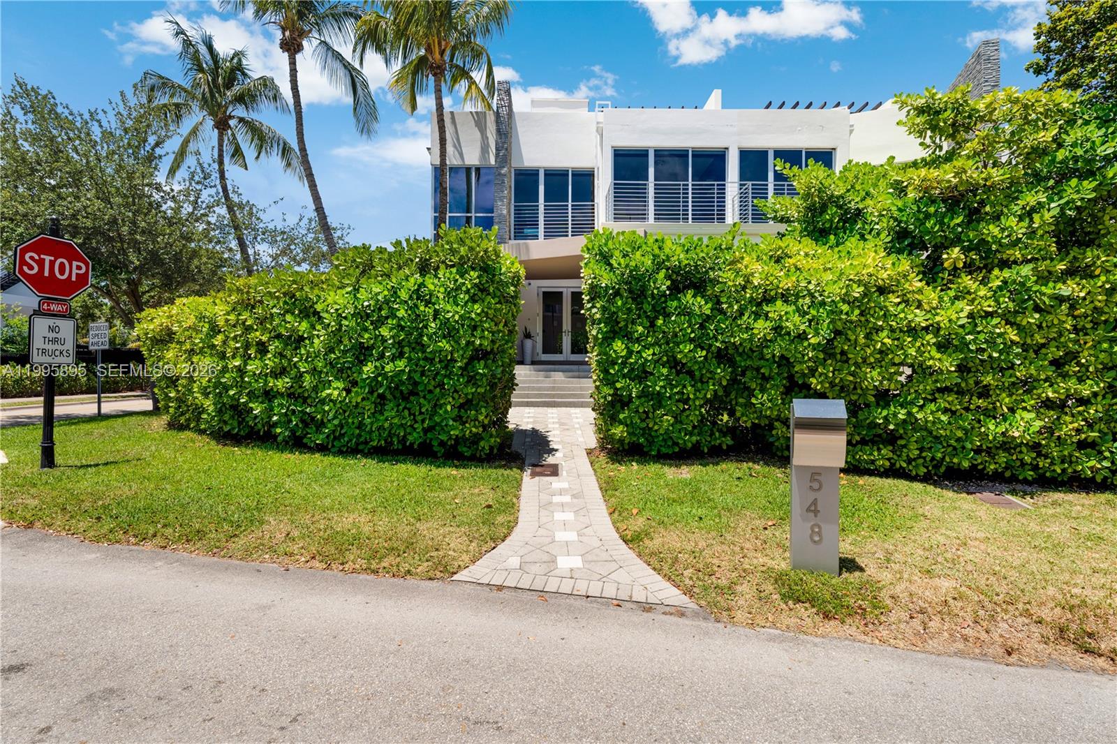548 Fernwood Road, Unit 548 Key Biscayne, FL 33149 - Photo 40 of 50 a front view of a house with garden