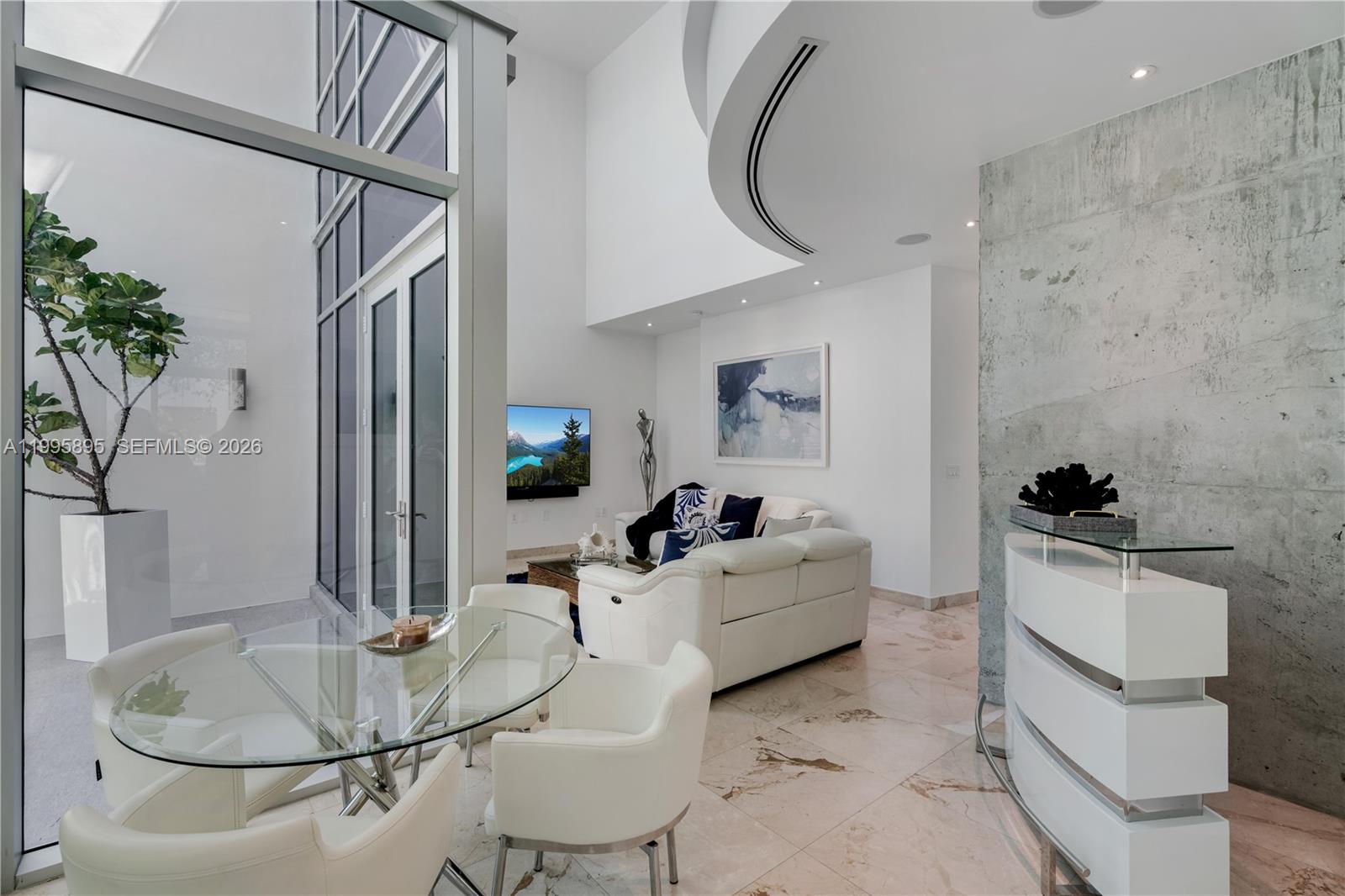 548 Fernwood Road, Unit 548 Key Biscayne, FL 33149 - Photo 4 of 50 a living room with furniture and a chandelier