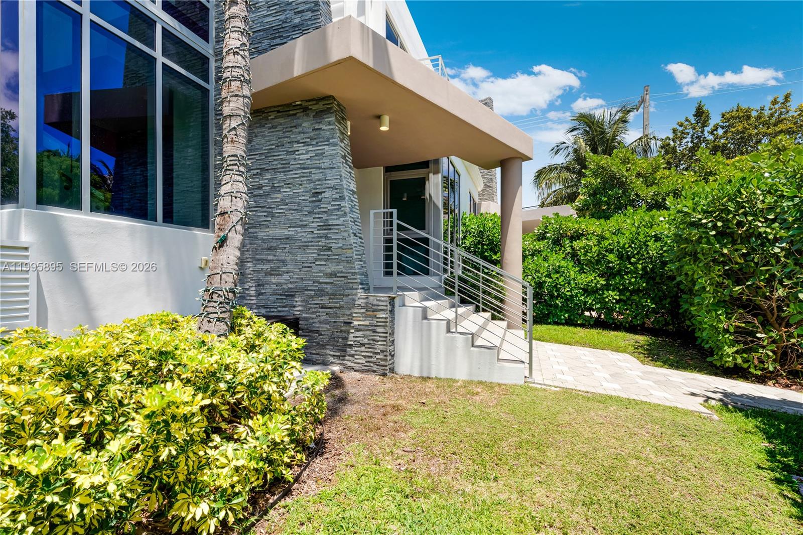 548 Fernwood Road, Unit 548 Key Biscayne, FL 33149 - Photo 42 of 50 a view of yellow house with a yard
