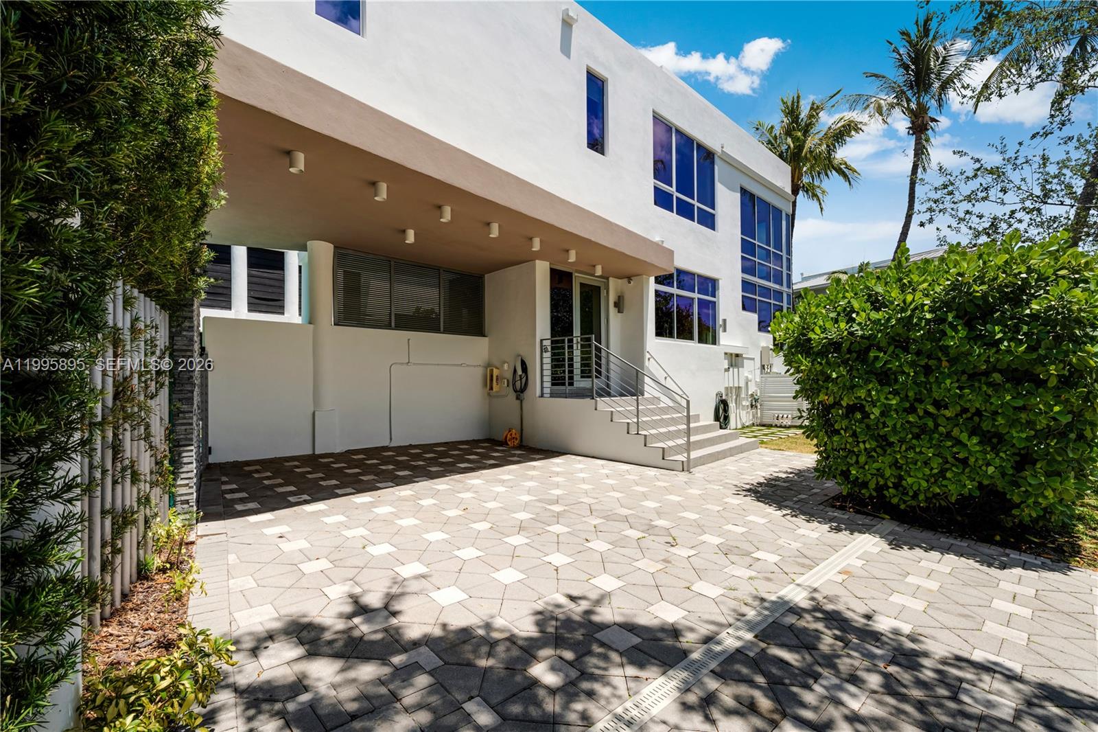548 Fernwood Road, Unit 548 Key Biscayne, FL 33149 - Photo 43 of 50 a front view of a house with a large tree