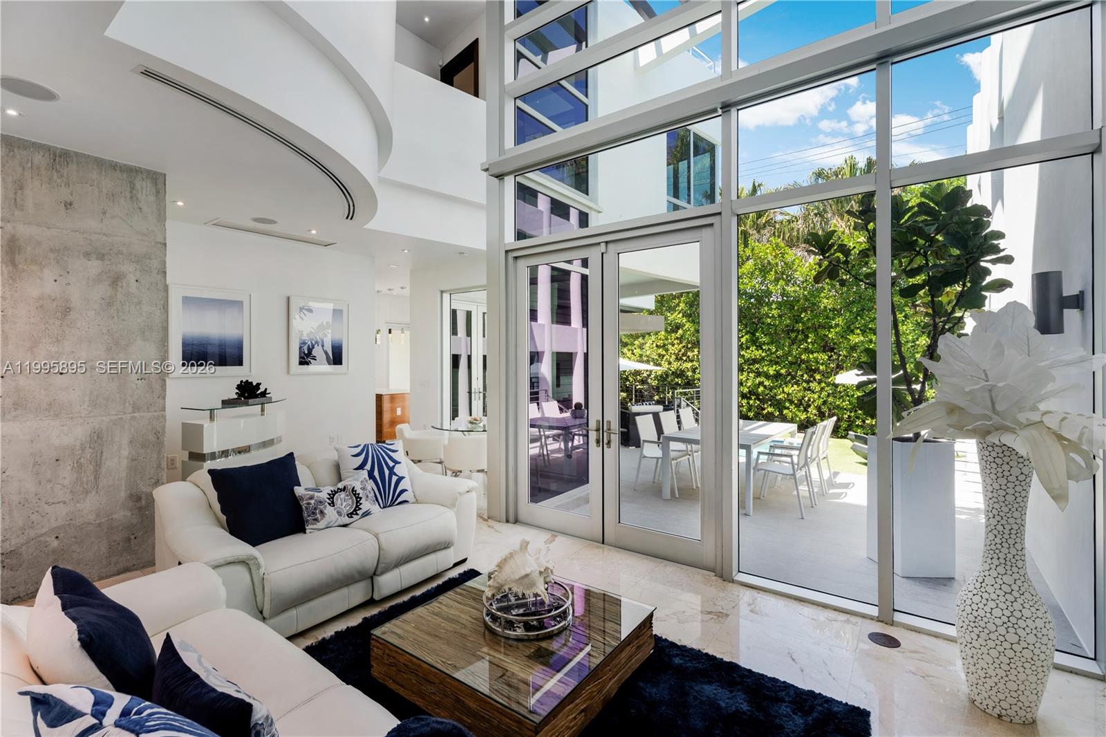 548 Fernwood Road, Unit 548 Key Biscayne, FL 33149 - Photo 6 of 50 a living room with furniture and a floor to ceiling window
