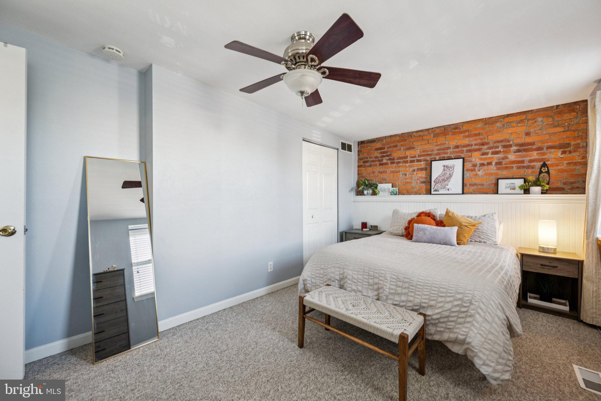 2731 Hudson Street Baltimore, MD 21224 - Photo 17 of 35 a bedroom with a bed and a table in it