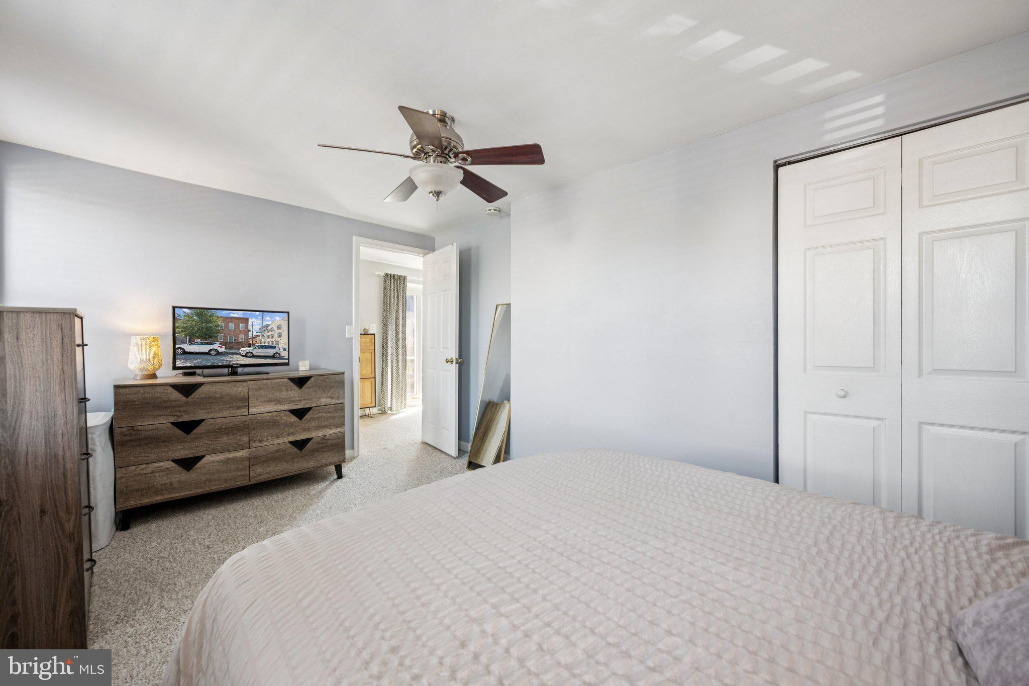 2731 Hudson Street Baltimore, MD 21224 - Photo 19 of 35 a bedroom with a bed and wooden floor