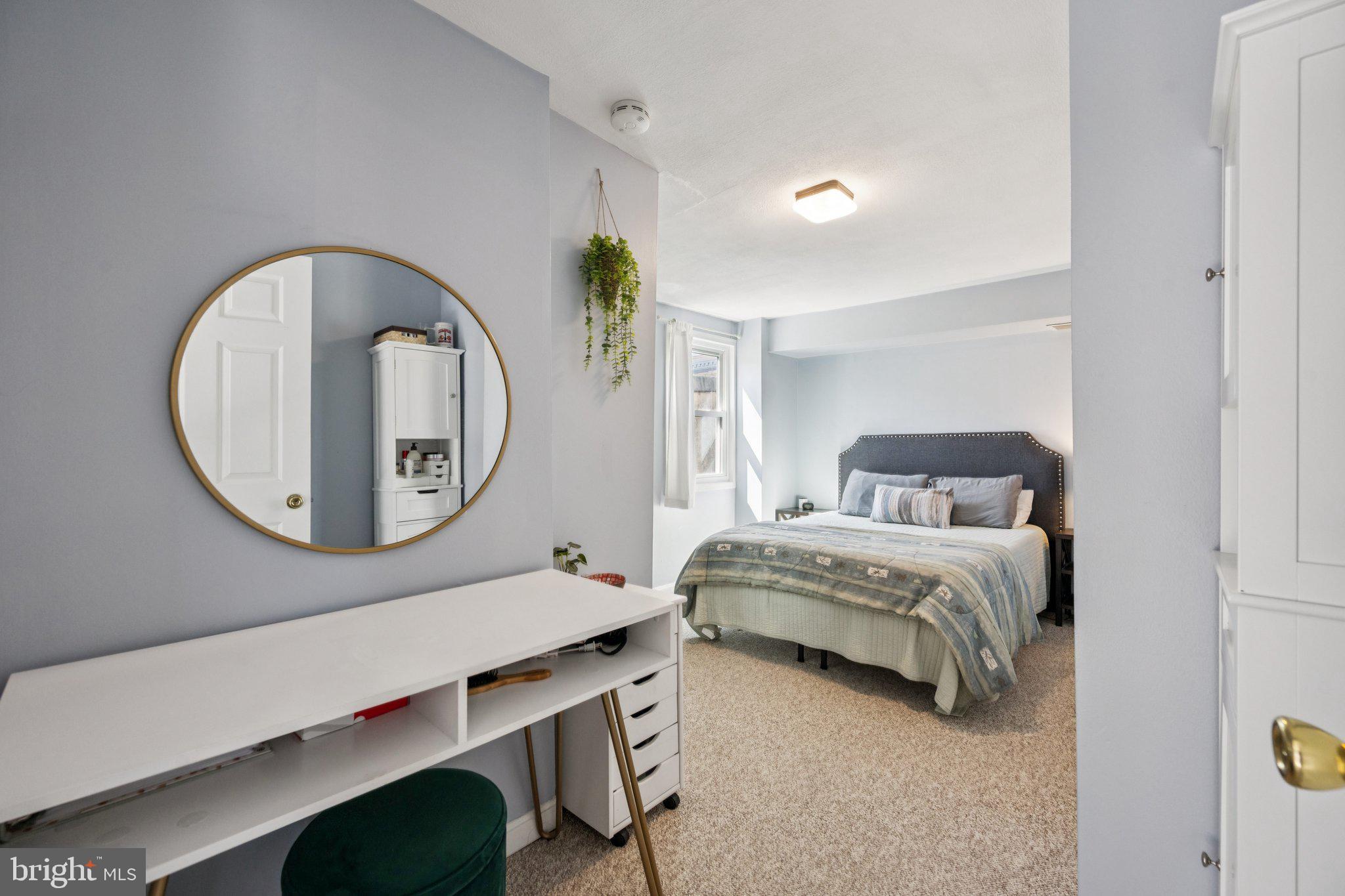 2731 Hudson Street Baltimore, MD 21224 - Photo 20 of 35 a living room with a bed furniture and a mirror