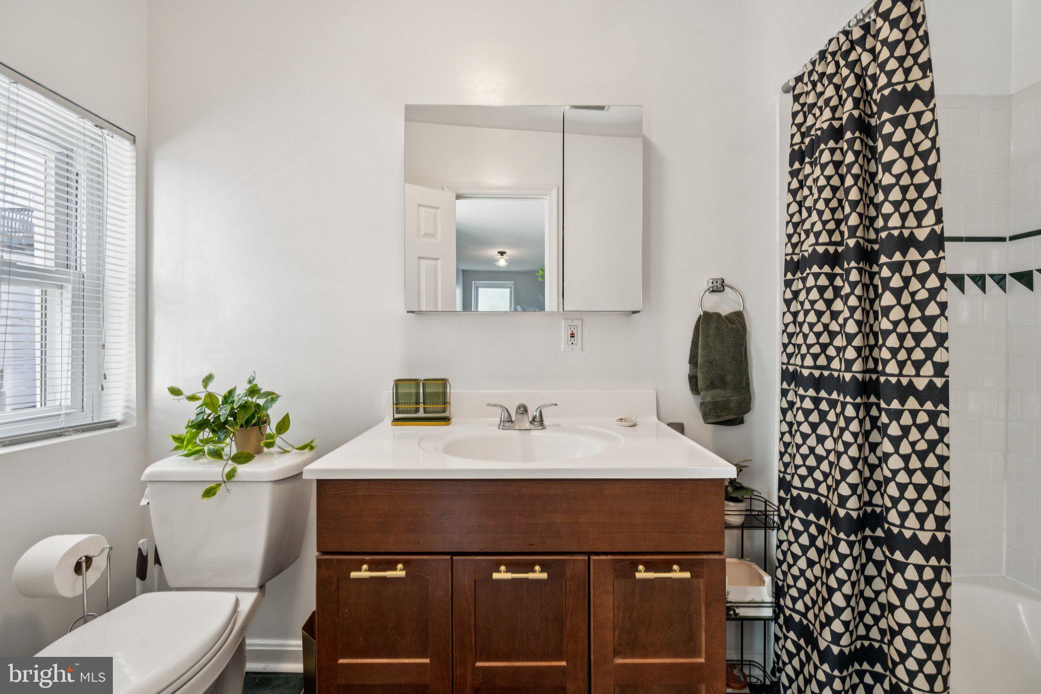 2731 Hudson Street Baltimore, MD 21224 - Photo 25 of 35 a bathroom with a sink toilet and shower