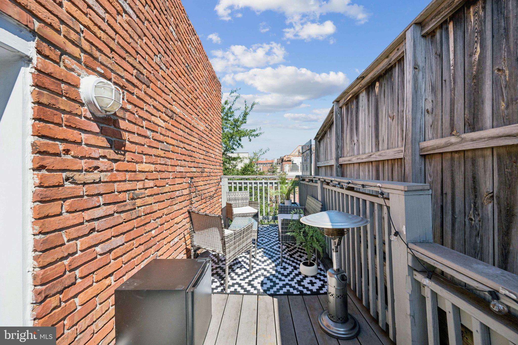 2731 Hudson Street Baltimore, MD 21224 - Photo 30 of 35 a view of a chair and tables in the balcony