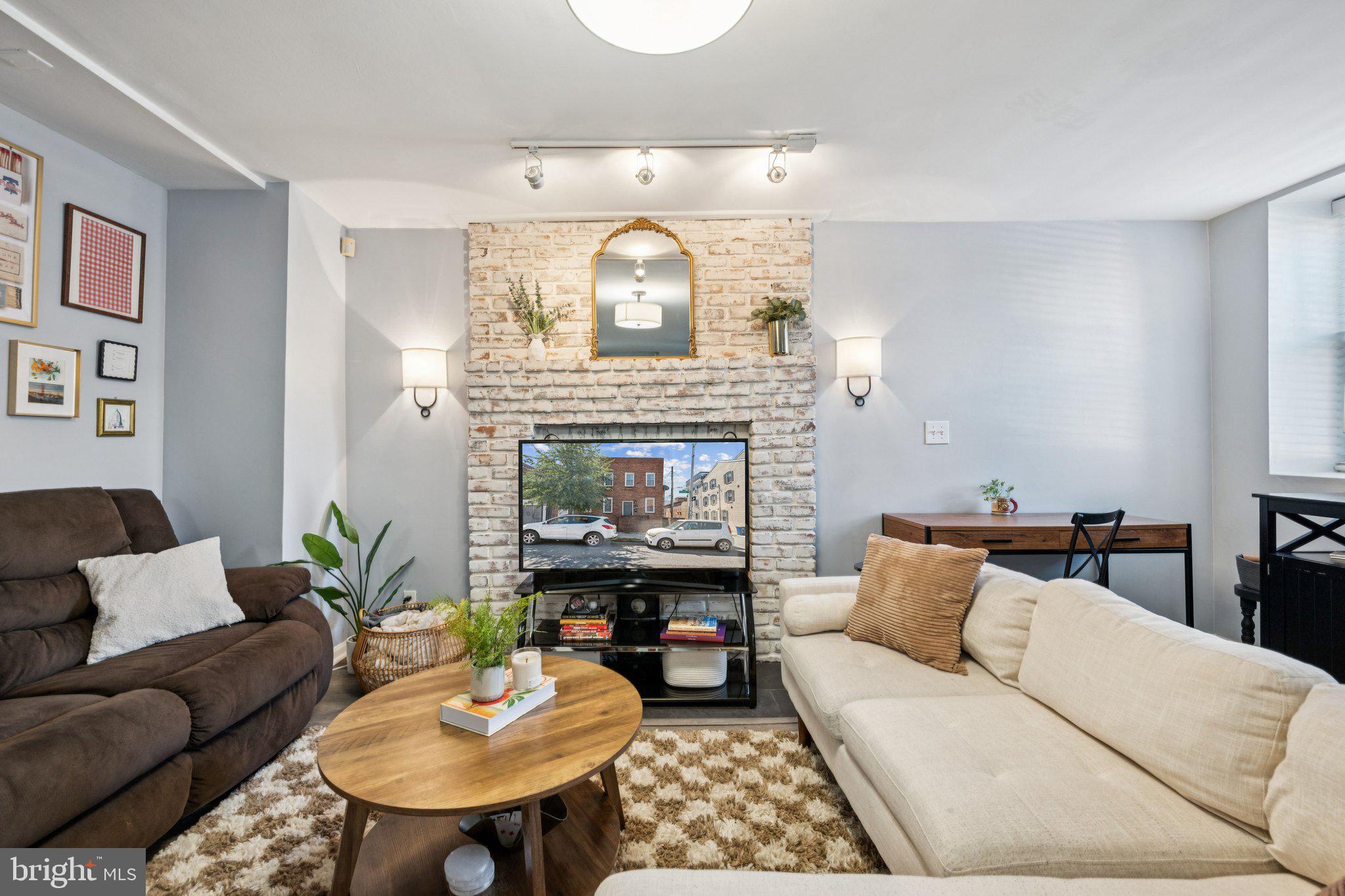 2731 Hudson Street Baltimore, MD 21224 - Photo 3 of 35 a living room with furniture and a fireplace