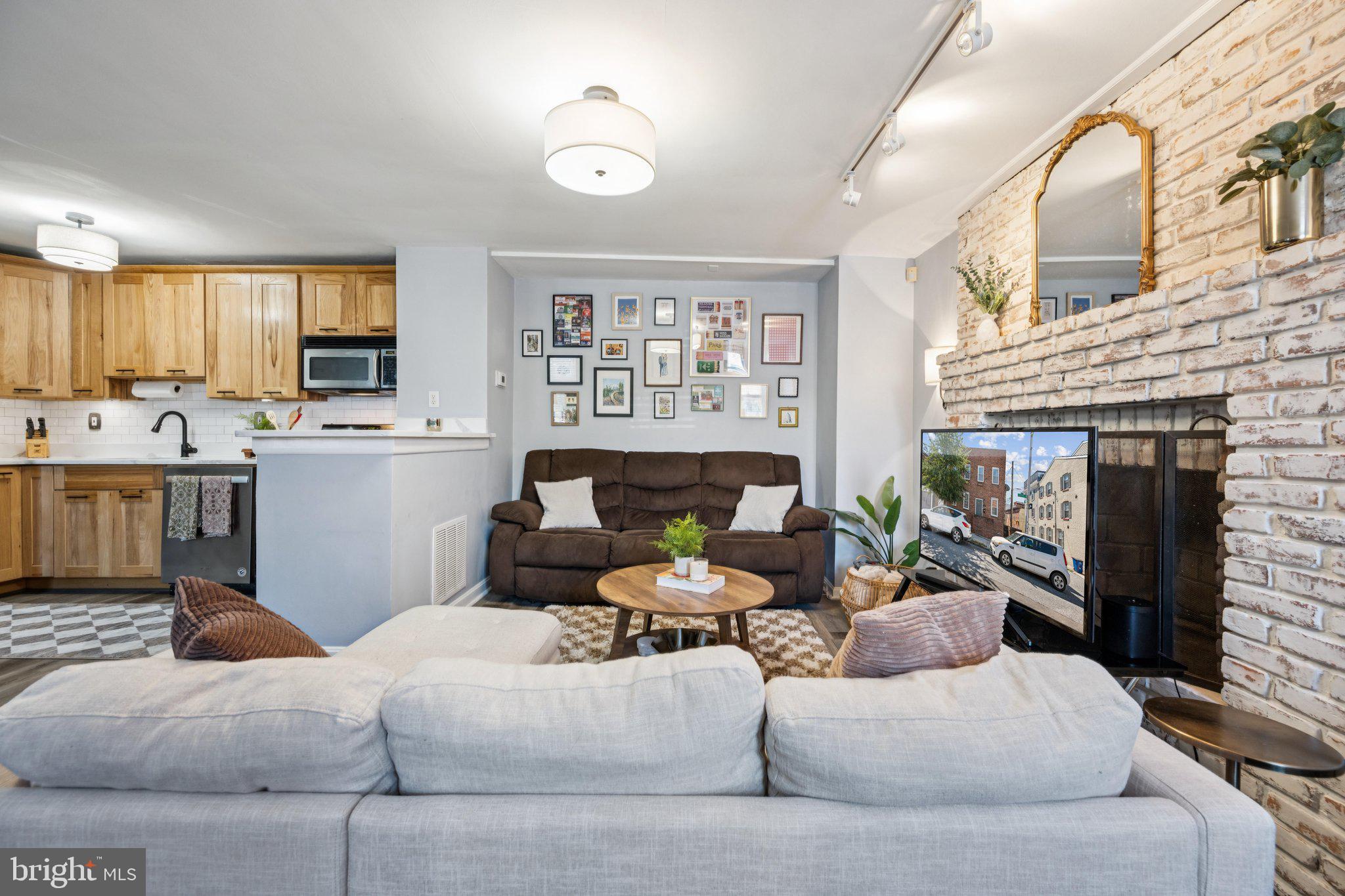 2731 Hudson Street Baltimore, MD 21224 - Photo 4 of 35 a living room with furniture and a fireplace