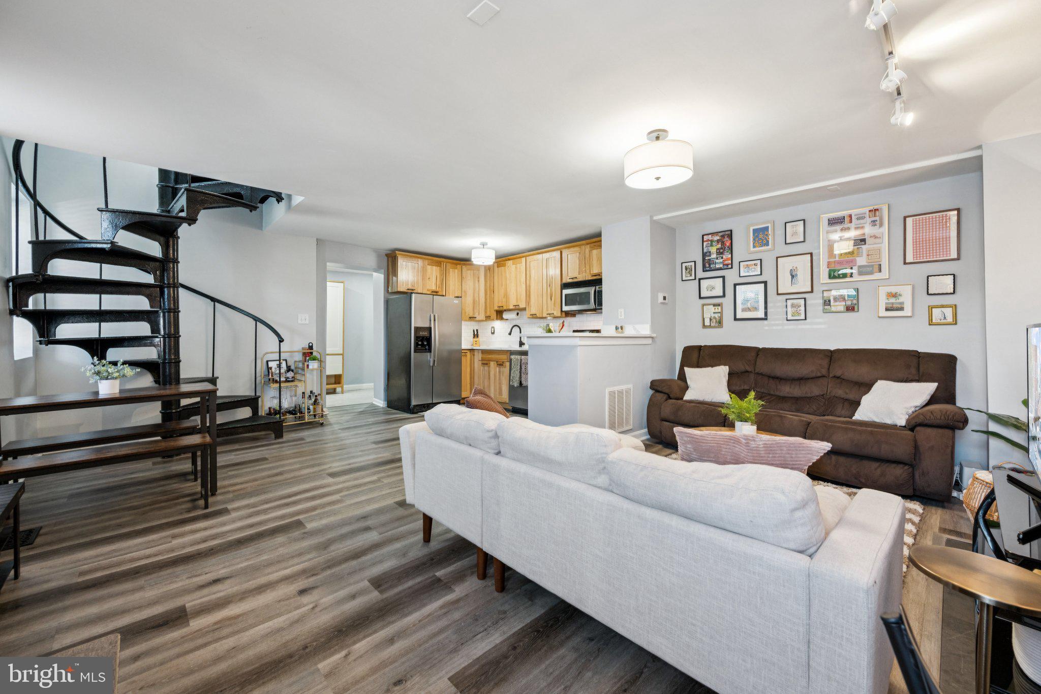2731 Hudson Street Baltimore, MD 21224 - Photo 5 of 35 a living room with furniture and a wooden floor