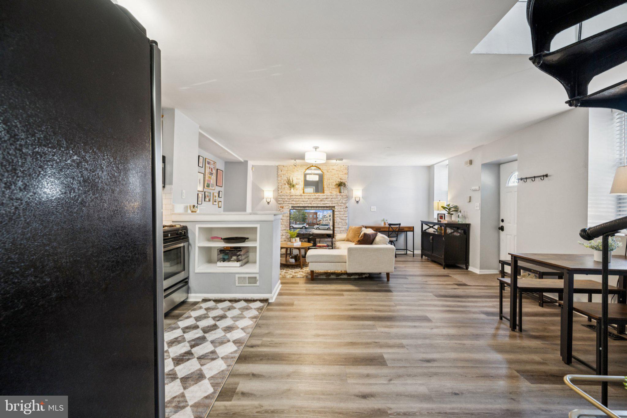 2731 Hudson Street Baltimore, MD 21224 - Photo 7 of 35 a living room with fireplace furniture and a wooden floor