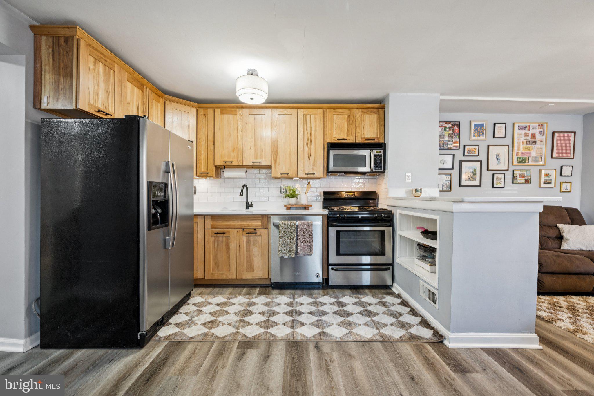 2731 Hudson Street Baltimore, MD 21224 - Photo 8 of 35 a kitchen with a refrigerator stove and sink