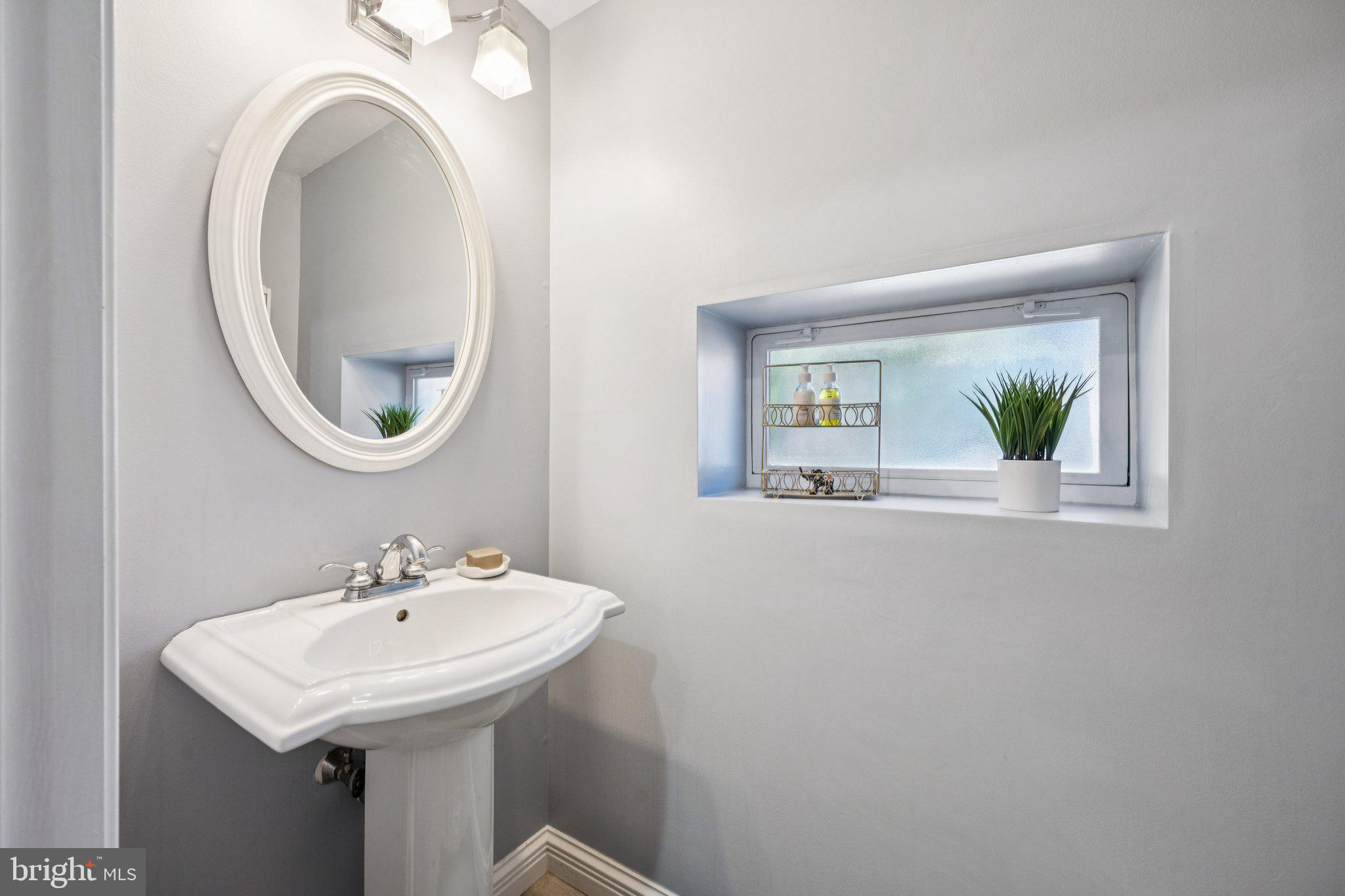 2731 Hudson Street Baltimore, MD 21224 - Photo 10 of 35 a bathroom with a sink and a mirror