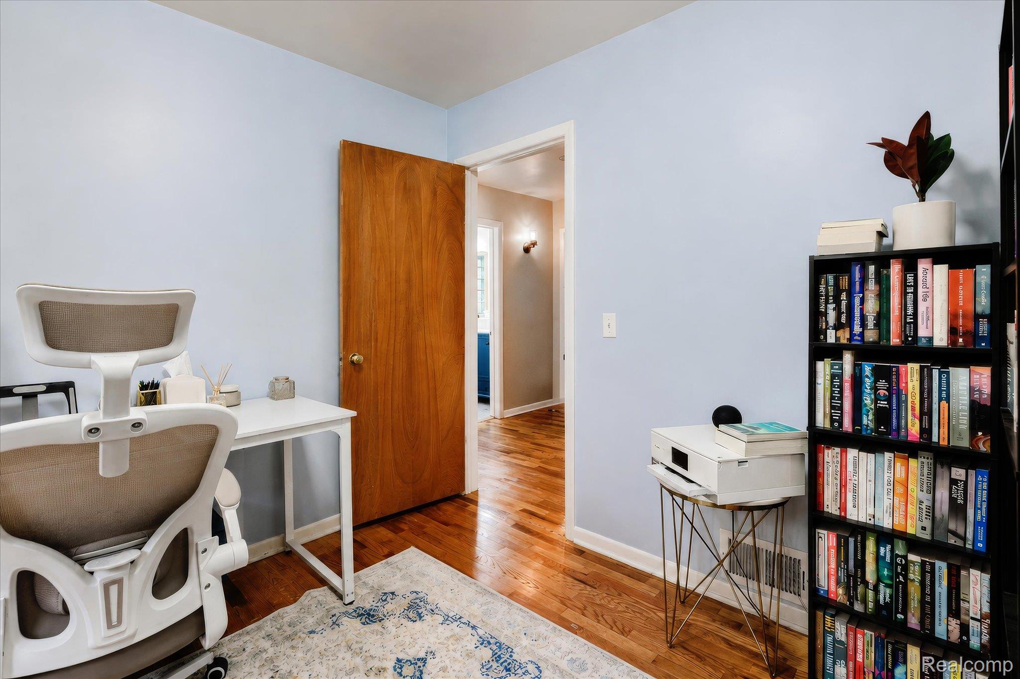 4499 South Linden Road Flint, MI 48507 - Photo 24 of 32 Light blue painted walls with wood-finish flooring