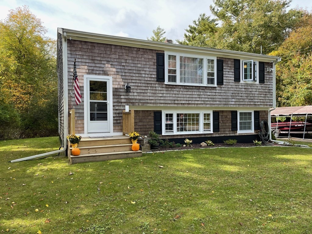 547 Delano Road Marion, MA 02738 - Photo 1 of 28 a view of a house with a yard and sitting area