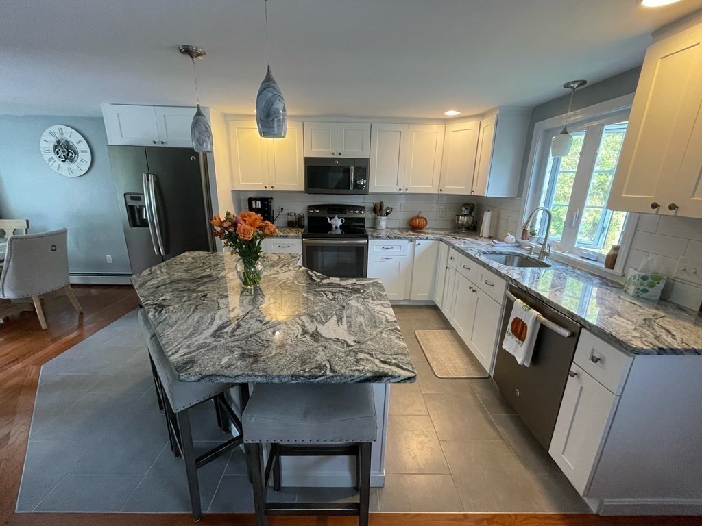547 Delano Road Marion, MA 02738 - Photo 9 of 28 a kitchen with granite countertop kitchen island stainless steel appliances a sink counter space and a window