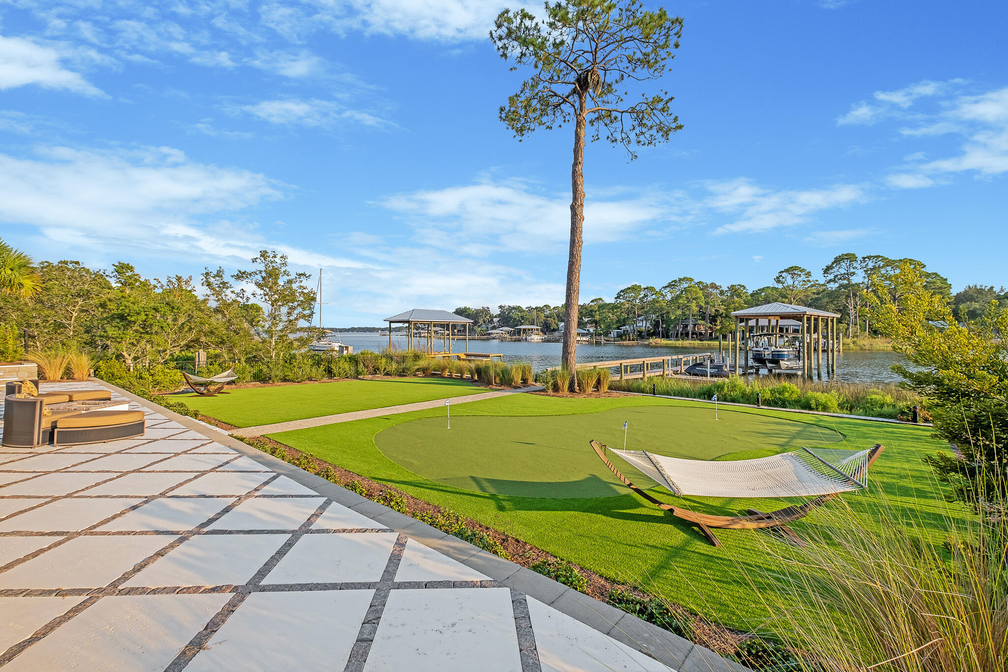 336 East Shipwreck Road Santa Rosa Beach, FL 32459 - Photo 37 of 50 a view of a swimming pool with a lawn chairs under an umbrella