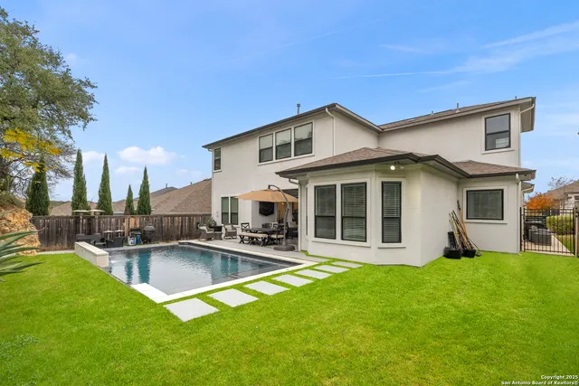 a view of a house with a yard patio and fire pit