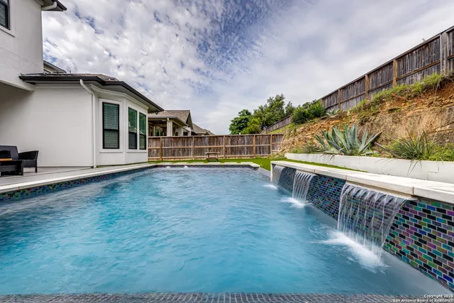 a view of swimming pool with seating space
