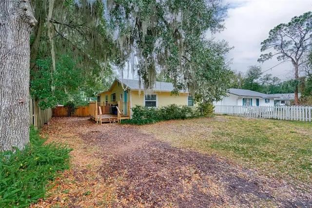 a view of a house with backyard and sitting area