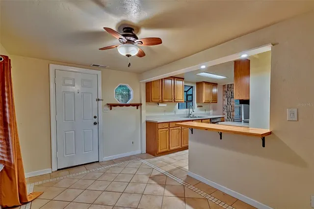a large kitchen with stainless steel appliances granite countertop a sink and cabinets