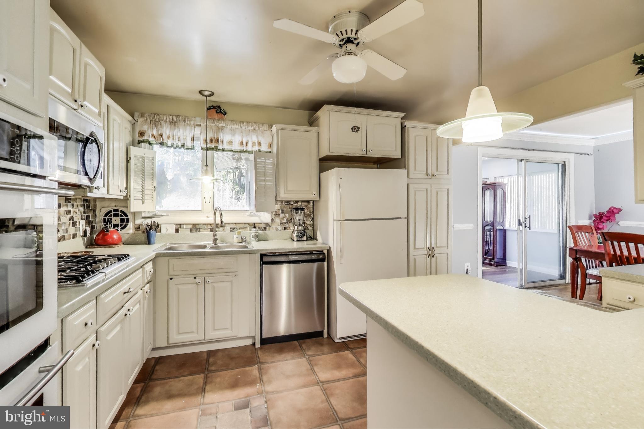 1804 Ironton Drive Oxon Hill, MD 20745 - Photo 11 of 37 a kitchen with sink a refrigerator and white cabinets