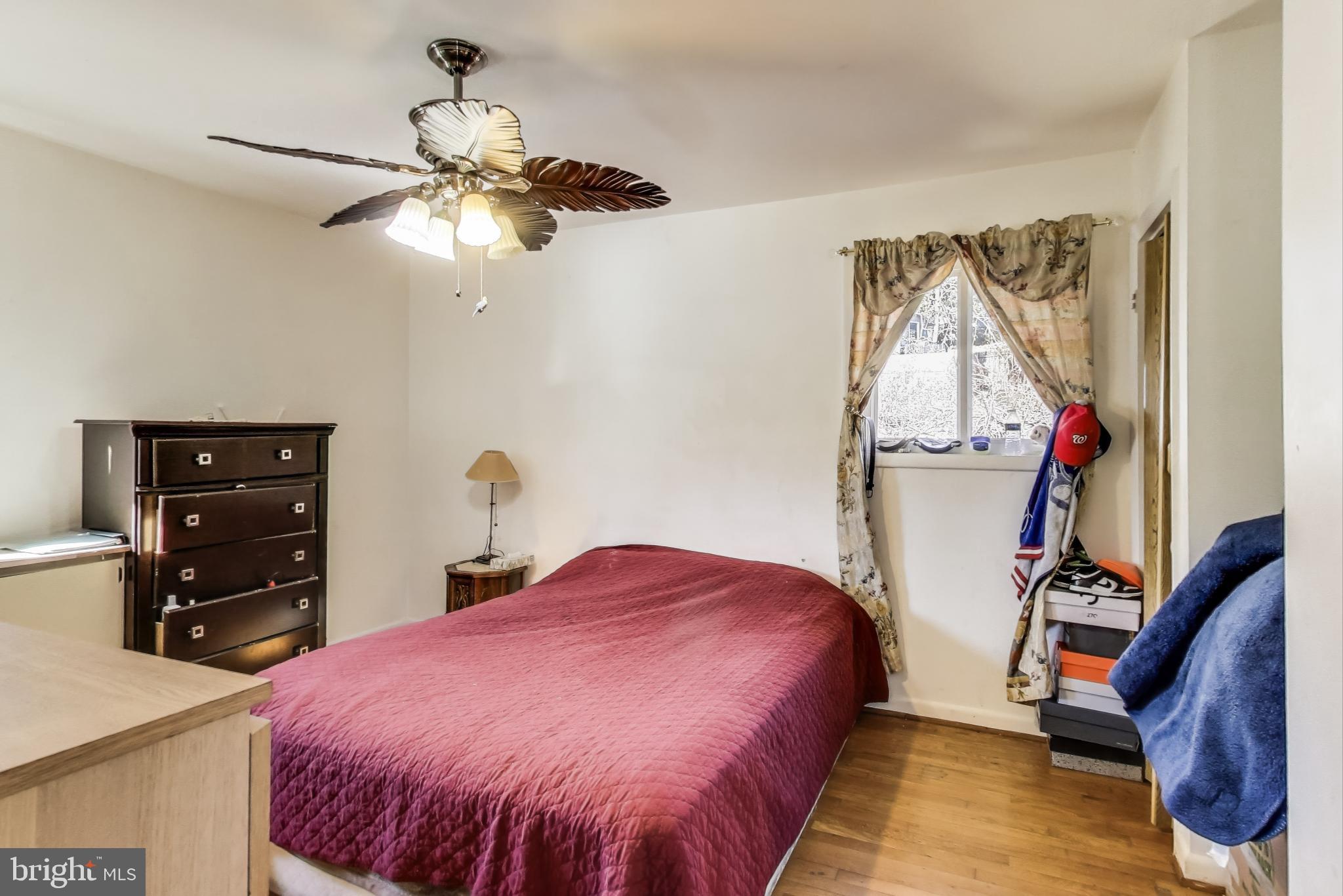 1804 Ironton Drive Oxon Hill, MD 20745 - Photo 16 of 37 a bedroom with a bed and a chandelier