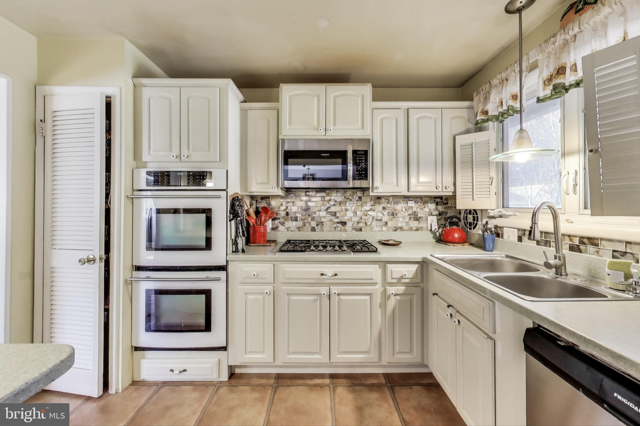1804 Ironton Drive Oxon Hill, MD 20745 - Photo 2 of 37 a kitchen with cabinets appliances a sink and a counter top space
