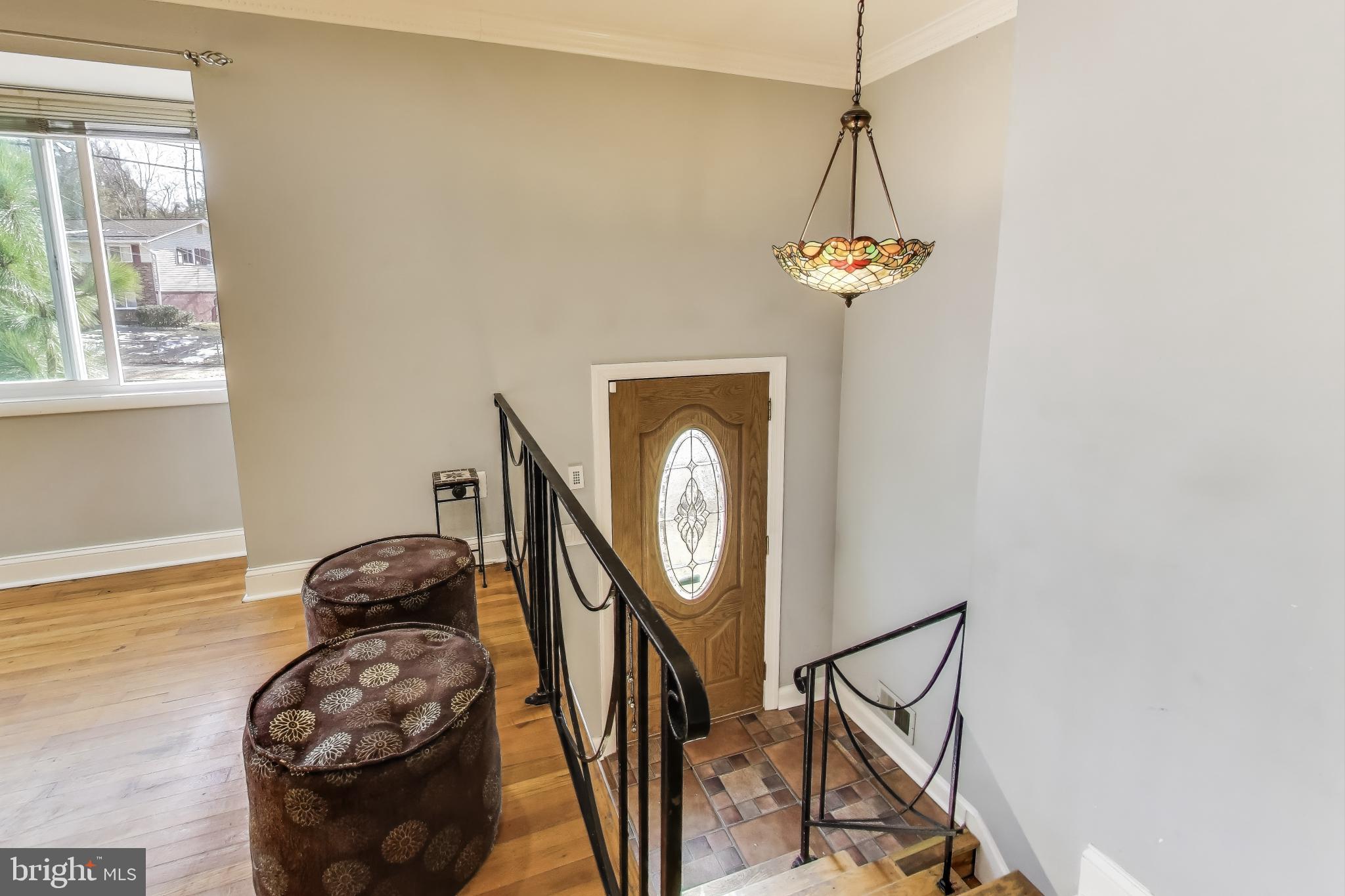 1804 Ironton Drive Oxon Hill, MD 20745 - Photo 23 of 37 a view of a hallway with entryway wooden floor and a chandelier