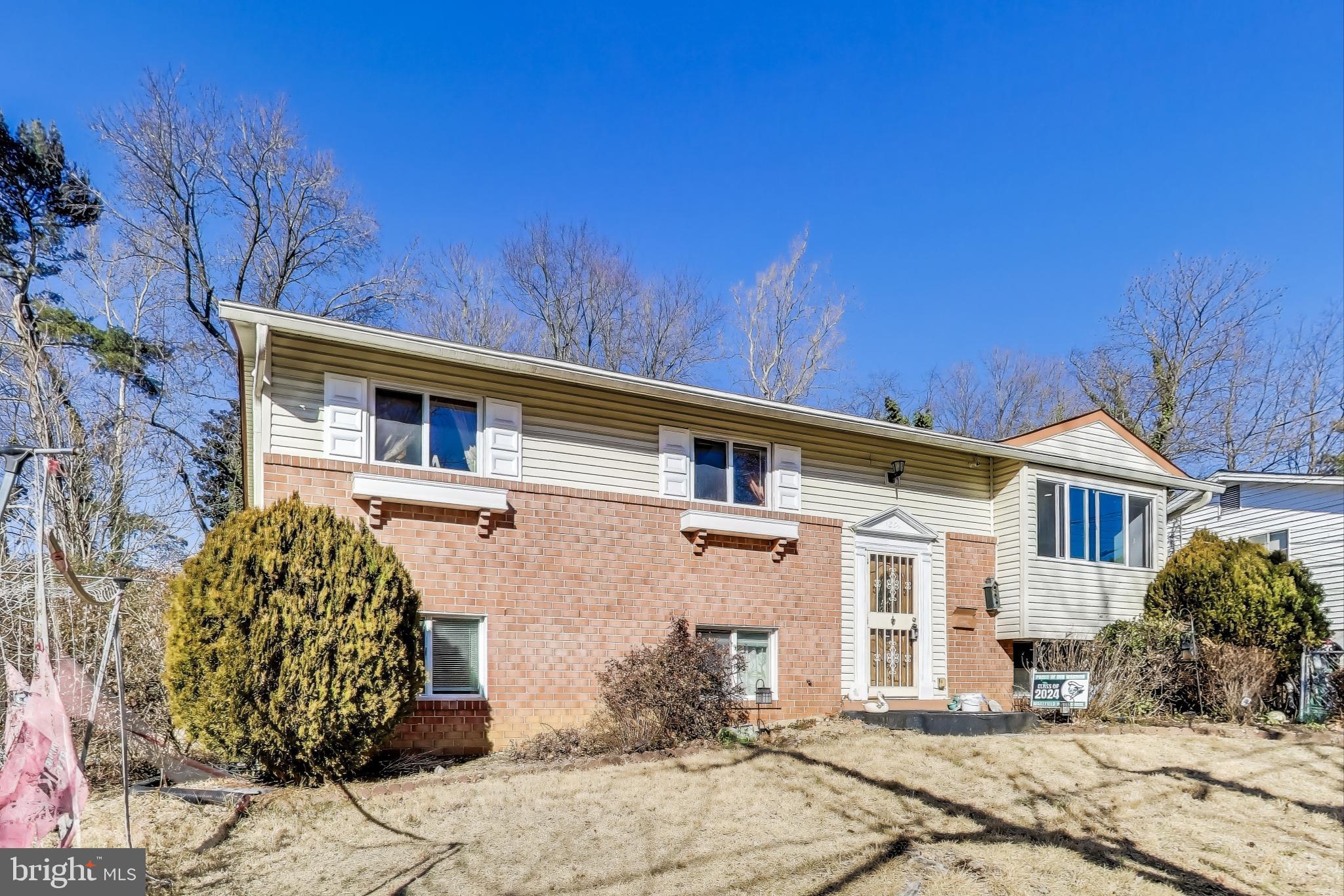 1804 Ironton Drive Oxon Hill, MD 20745 - Photo 3 of 37 a view of a white house with a flower garden in front of it