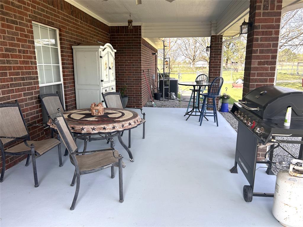 219 Friends Road Denison, TX 75021 - Photo 24 of 40 Concrete covered patio with lights and fan