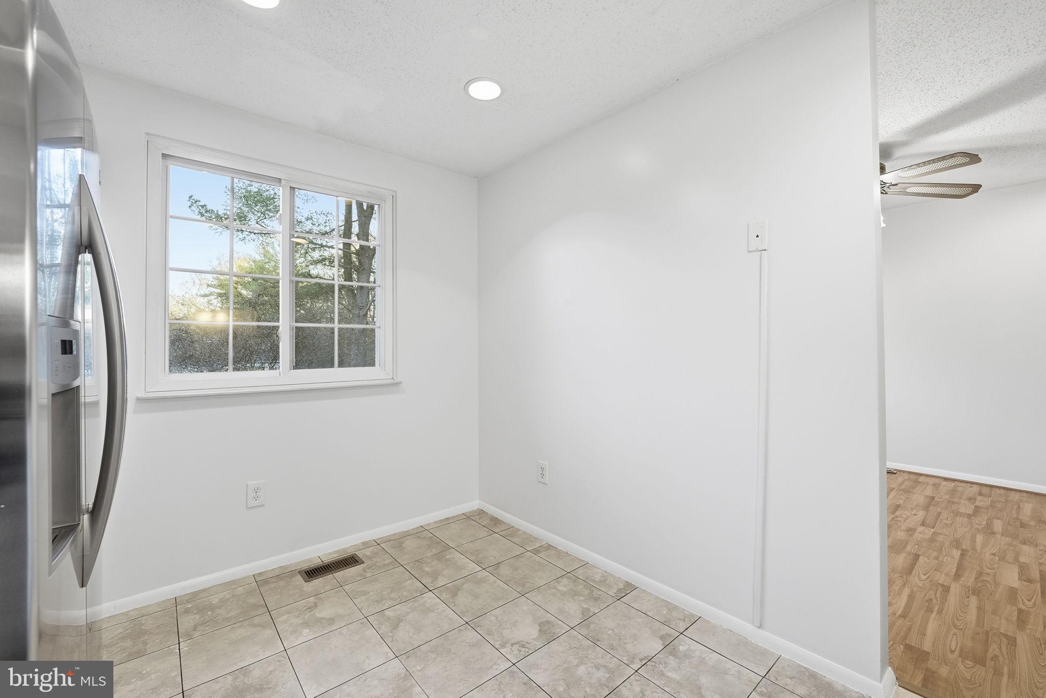 9804 Gabon Court Burke, VA 22015 - Photo 12 of 30 a view of empty room with windows