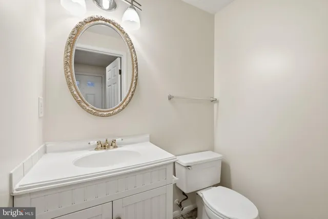 a bathroom with a sink a mirror and a toilet