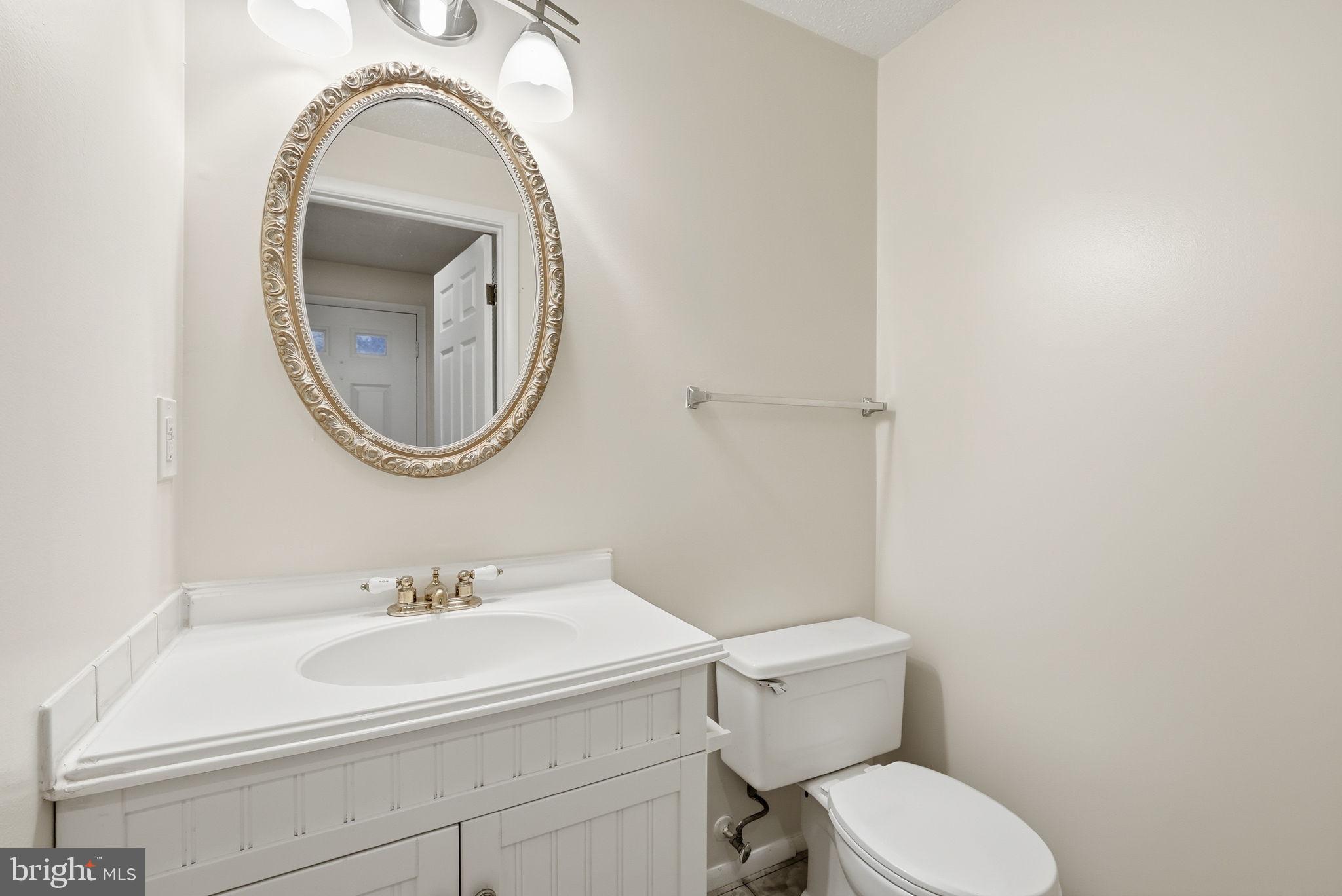 9804 Gabon Court Burke, VA 22015 - Photo 15 of 30 a bathroom with a sink a mirror and a toilet