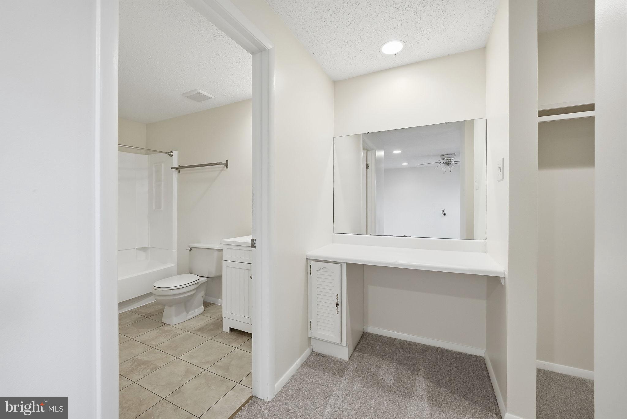 9804 Gabon Court Burke, VA 22015 - Photo 18 of 30 a bathroom with a toilet sink and mirror
