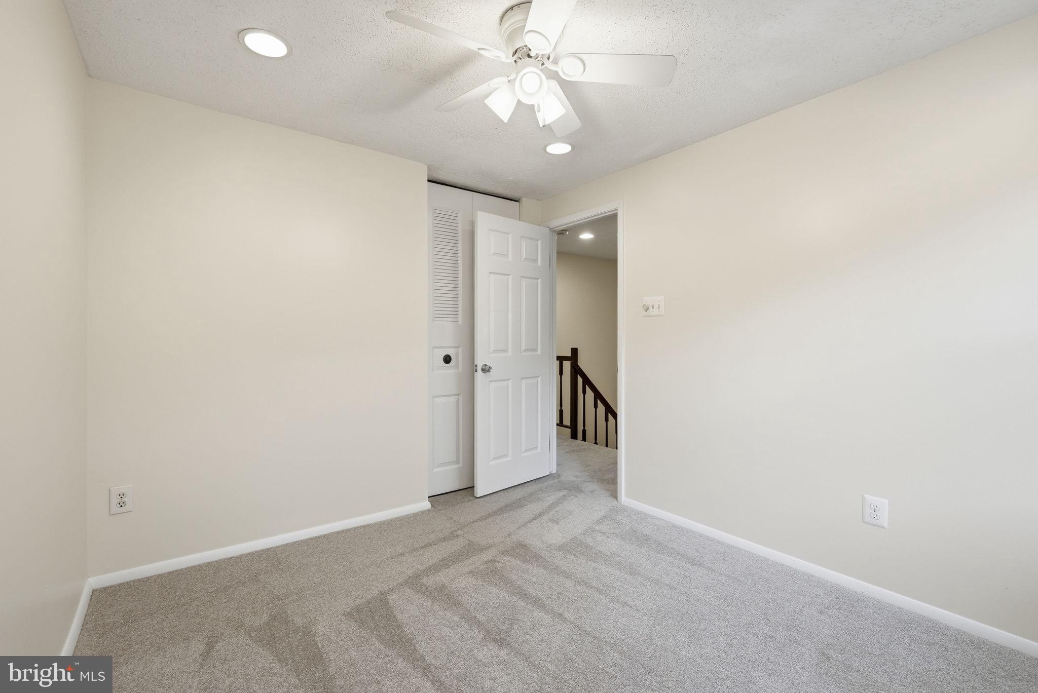 9804 Gabon Court Burke, VA 22015 - Photo 21 of 30 an empty room with a ceiling fan and a window
