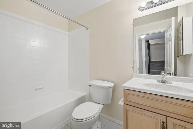 a bathroom with a sink a toilet a mirror and shower