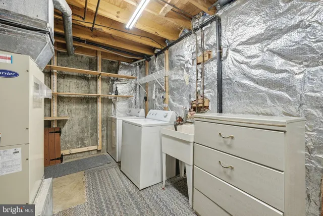 a utility room with cabinets washer and dryer