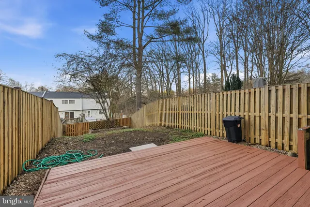 a view of a backyard with wooden fence