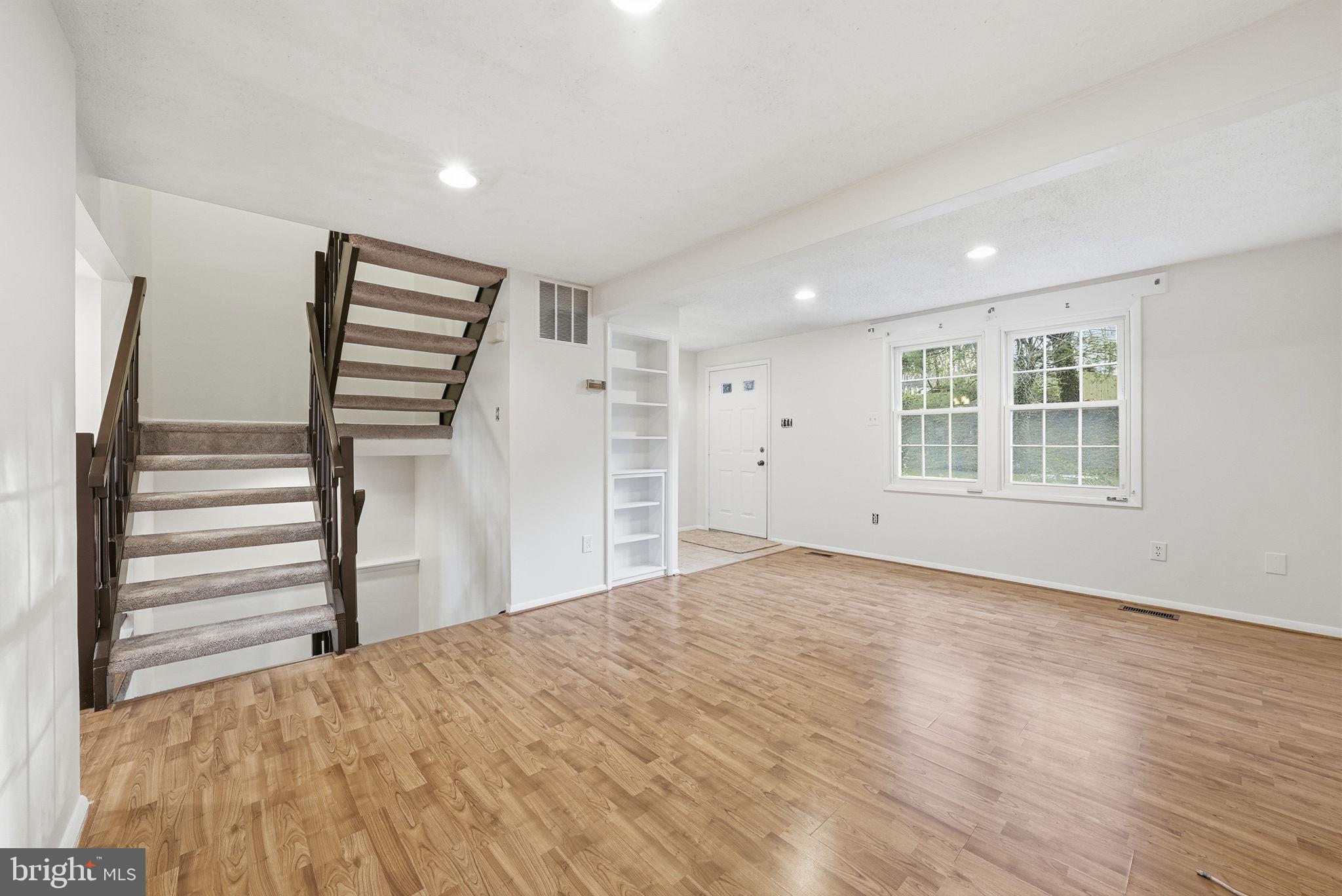 9804 Gabon Court Burke, VA 22015 - Photo 3 of 30 a view of empty room with wooden floor and window