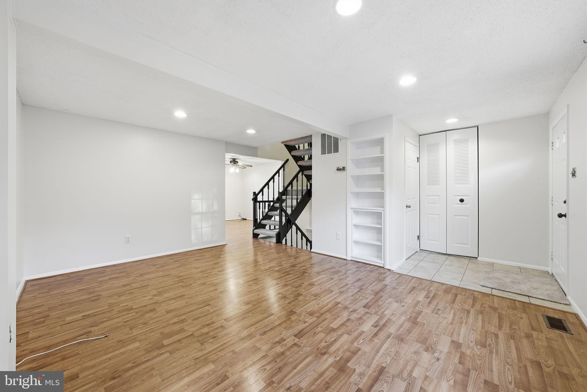 9804 Gabon Court Burke, VA 22015 - Photo 4 of 30 a view of empty room with wooden floor and stairs