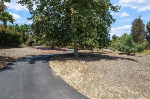 a view of a street with a yard