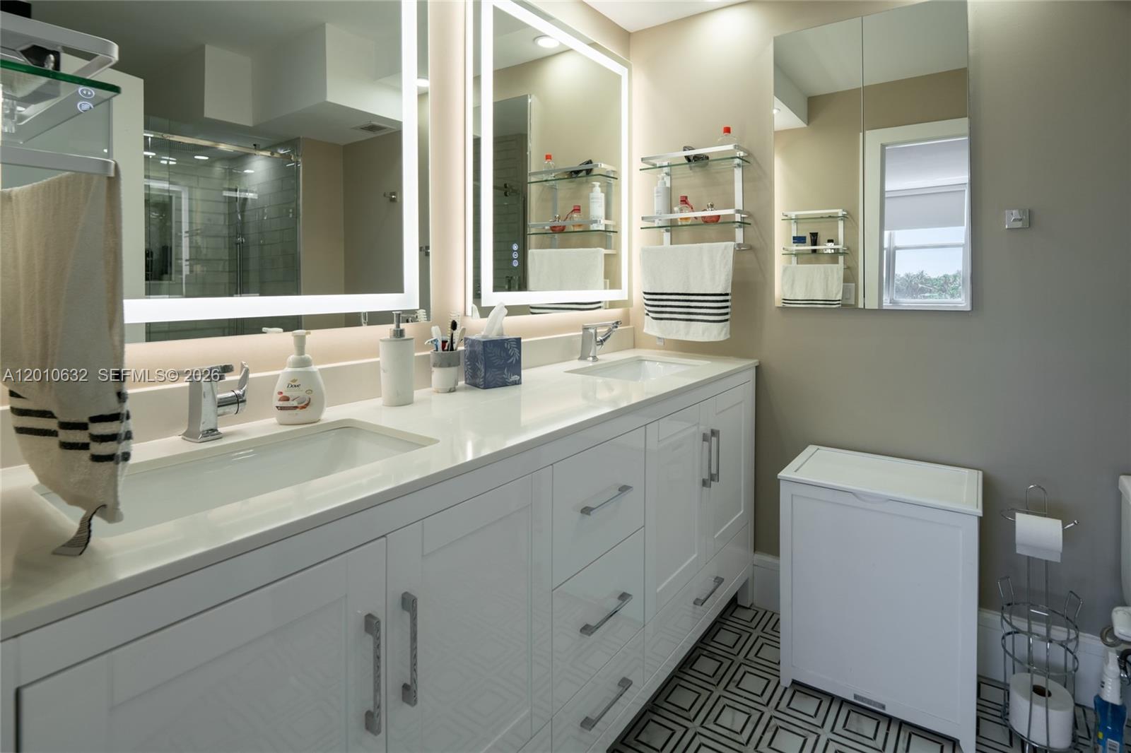 2639 North Riverside Drive, Unit 501 Pompano Beach, FL 33062 - Photo 21 of 39 a bathroom with double sink and a mirror