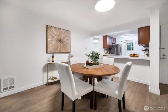 a view of a dining room with furniture and wooden floor