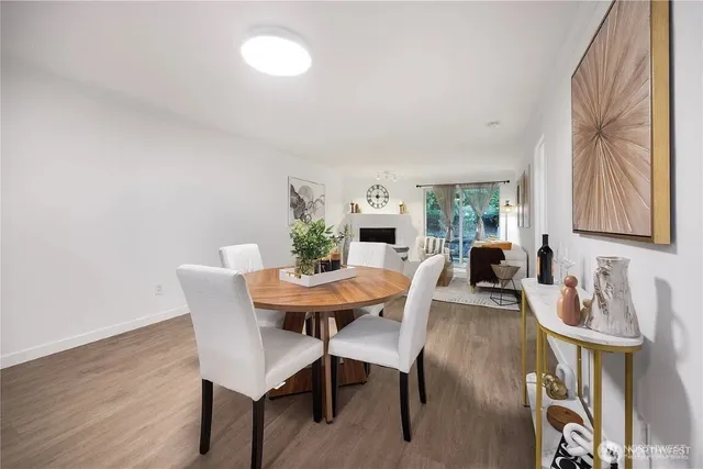 a view of a dining room with furniture and wooden floor